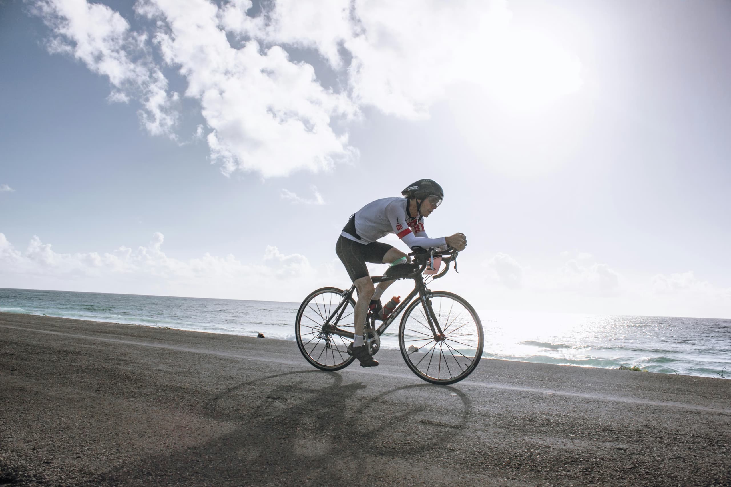 A cyclist riding on the beach
