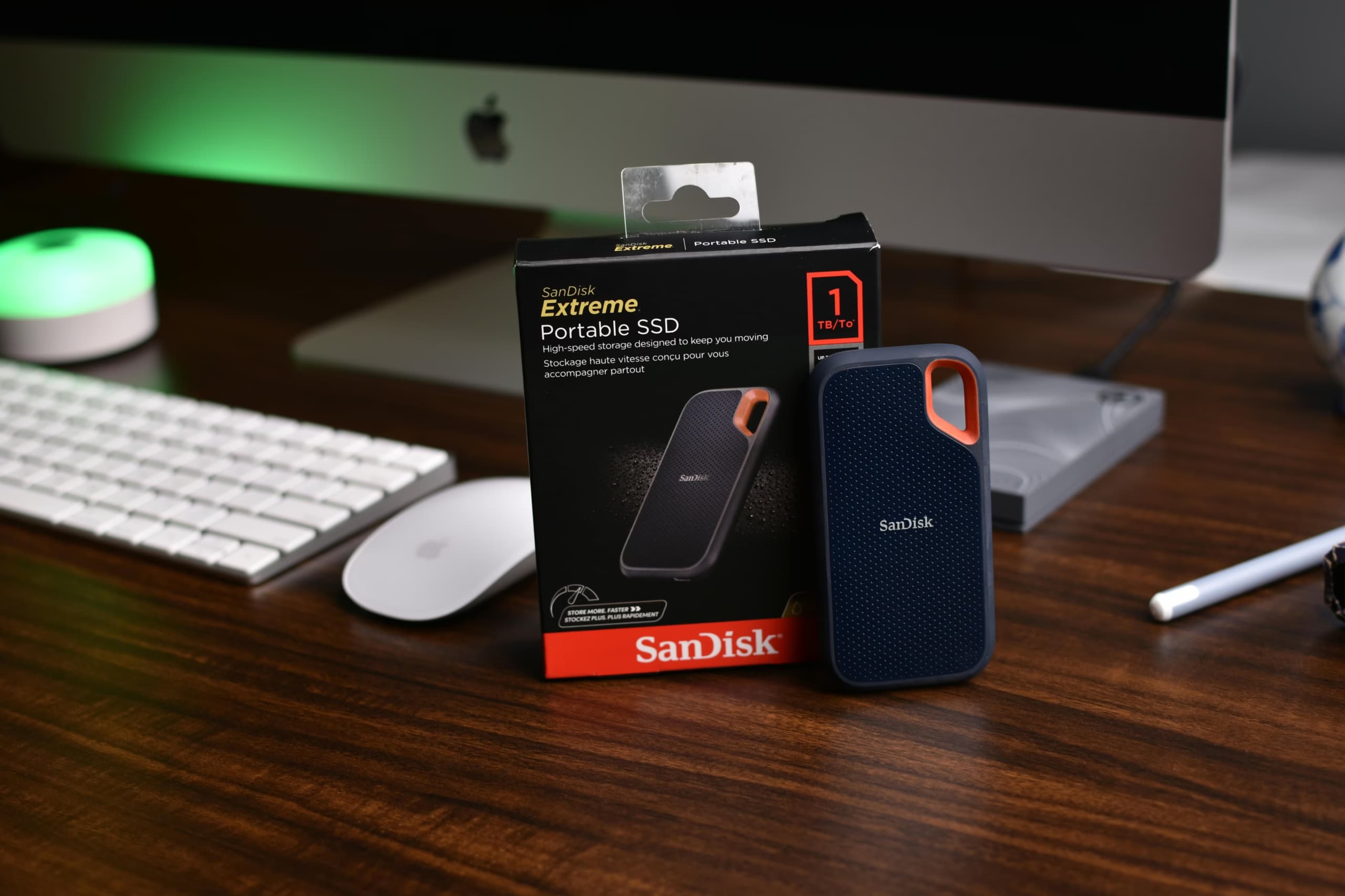 A sandisk solid state drive near imac computer