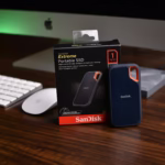 A sandisk solid state drive near imac computer