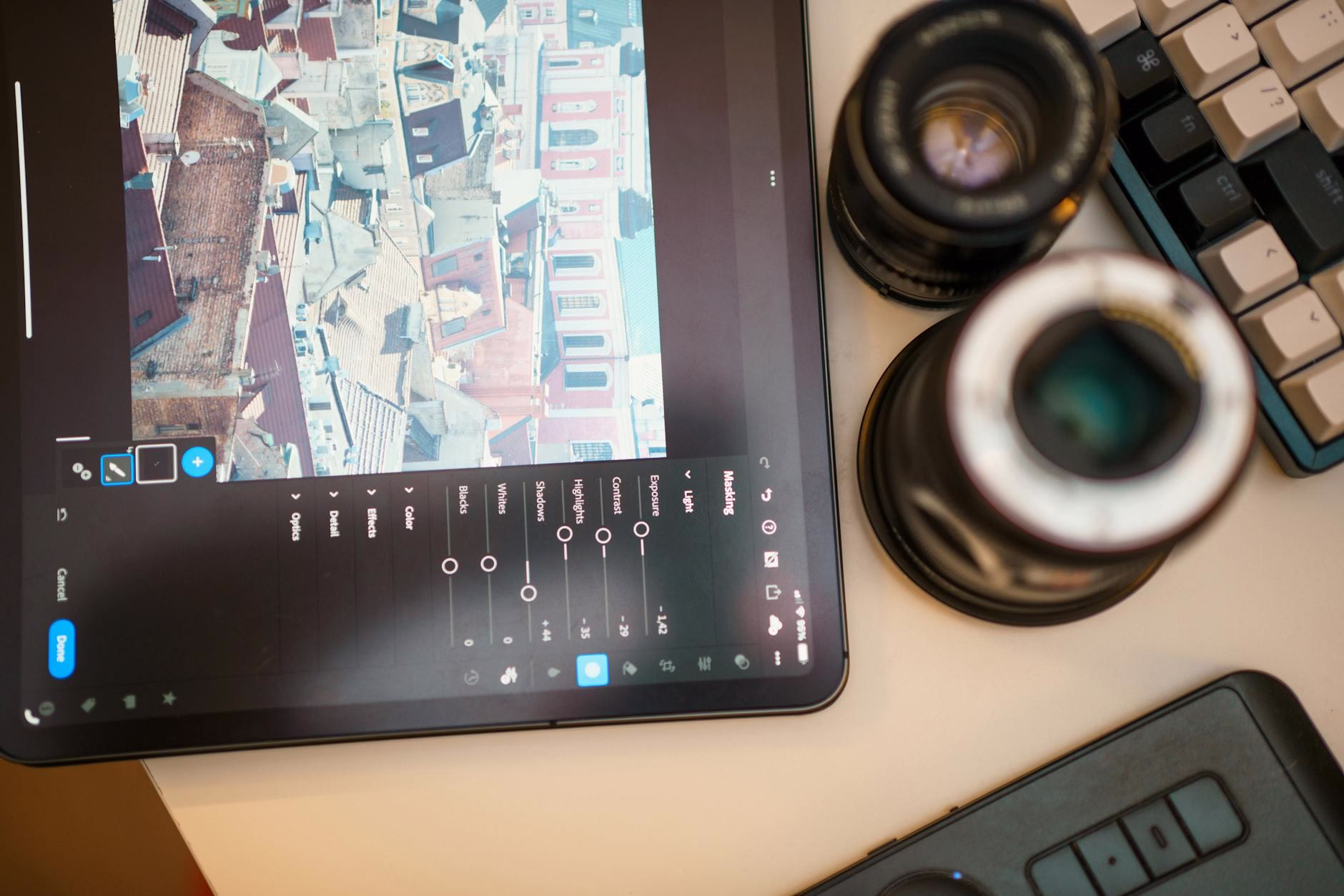 Espace de travail de retouche photo avec tablette et objectif